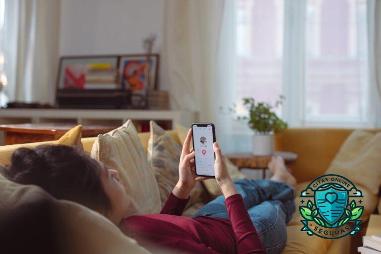 a person lying on sofa holding a smartphone with a person s profile on screen