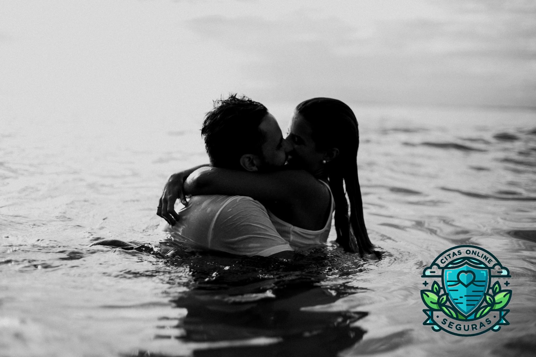 man and woman kissing together on body of water