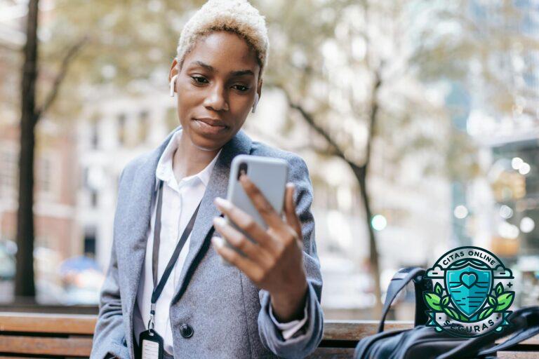 positive black woman reading text message on smartphone