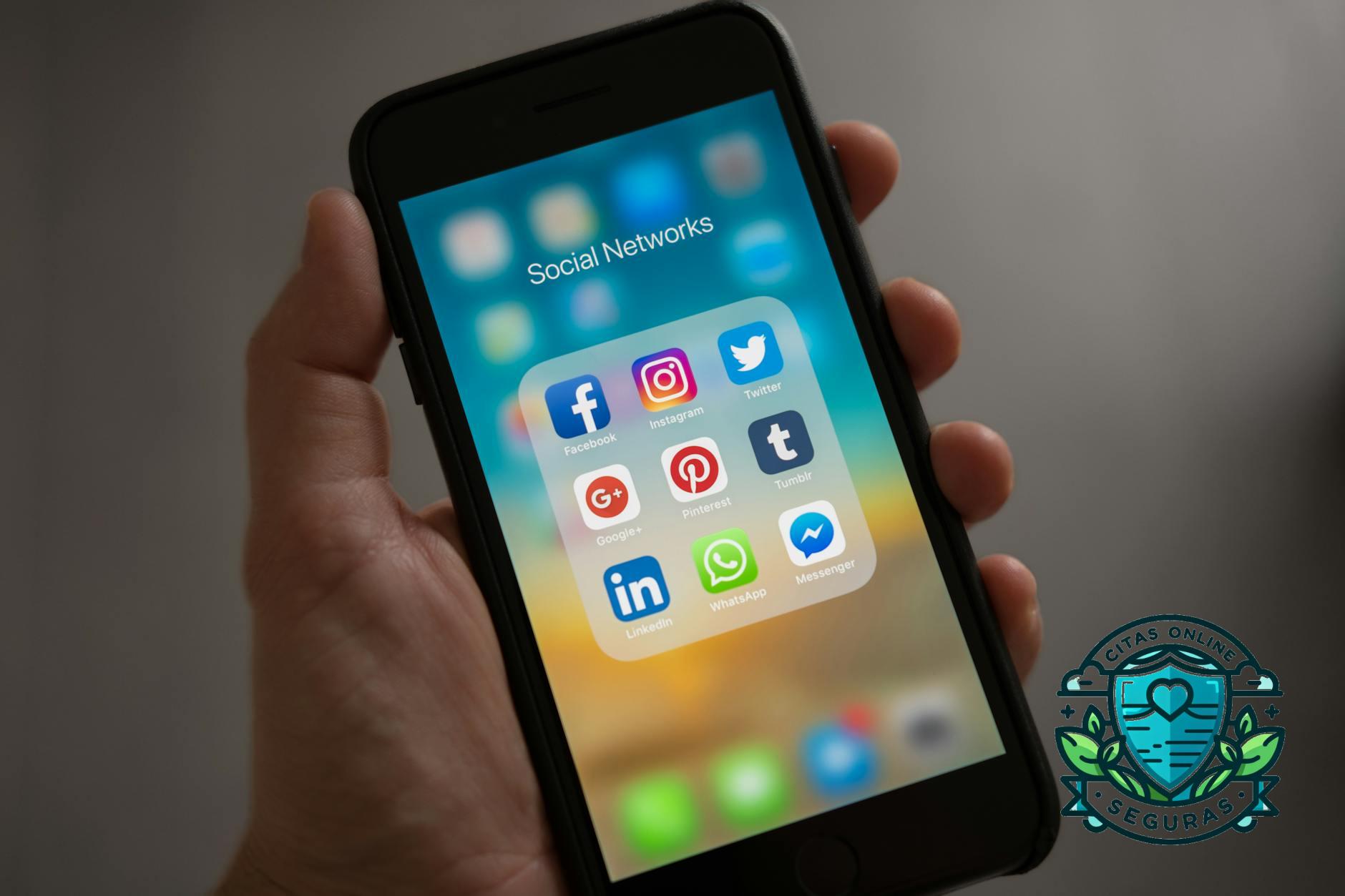 person holding iphone showing social networks folder